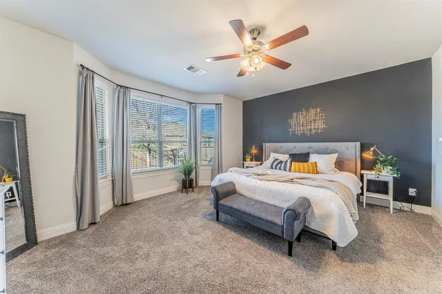 a spacious bedroom with a large bed and a large window