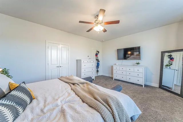 a bedroom with a bed and a chandelier