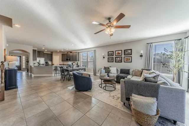 a living room with furniture a window and kitchen view