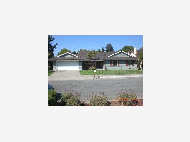 a picture of a bench in front of a house