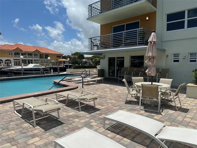 a roof deck with table and chairs
