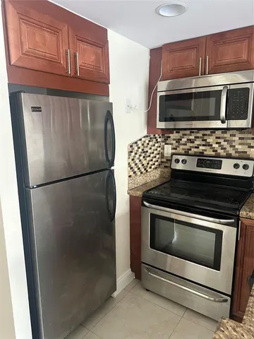 a kitchen with granite countertop cabinets and steel stainless steel appliances