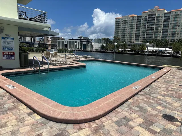 a view of a swimming pool with chairs