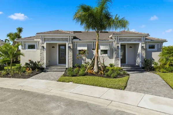 a front view of a house with a garden