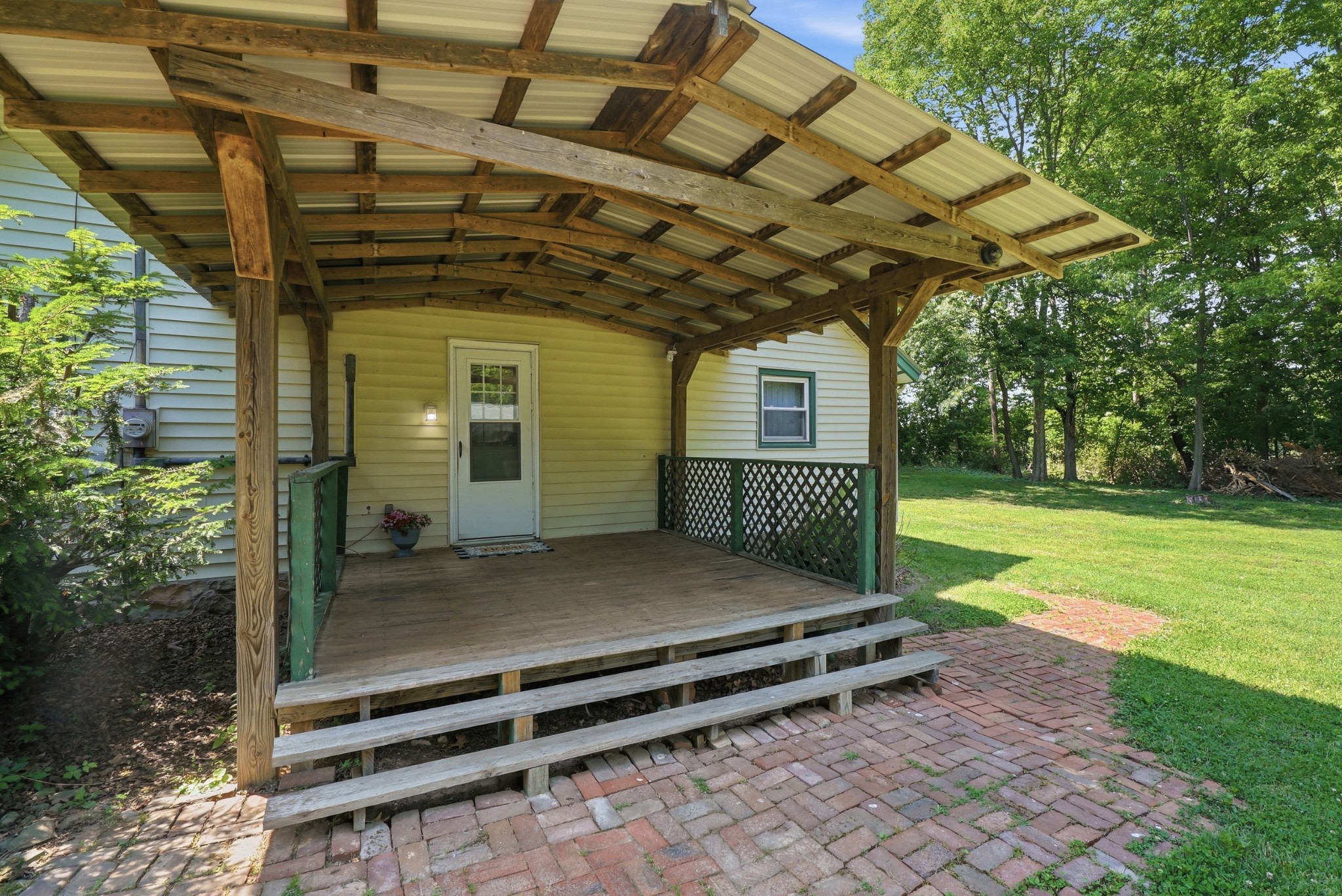 6471 Highway 161 Springfield, TN 37172 - Photo 41 of 57 a view of a porch with a table and chairs under an umbrella