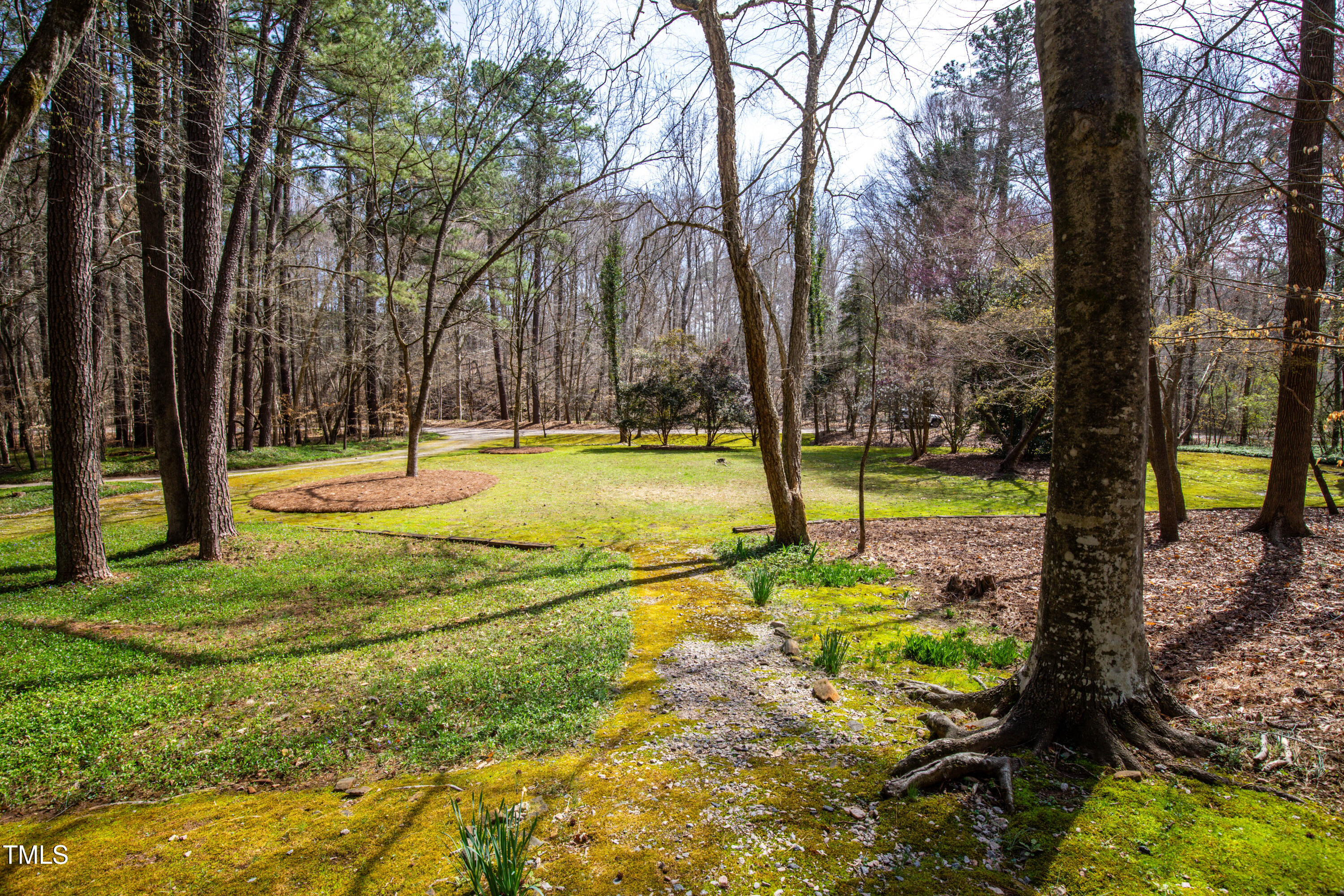 7409 Birch Tree Lane Wake Forest, NC 27587 - Photo 17 of 72 a view of a swimming pool with a sitting area and large trees