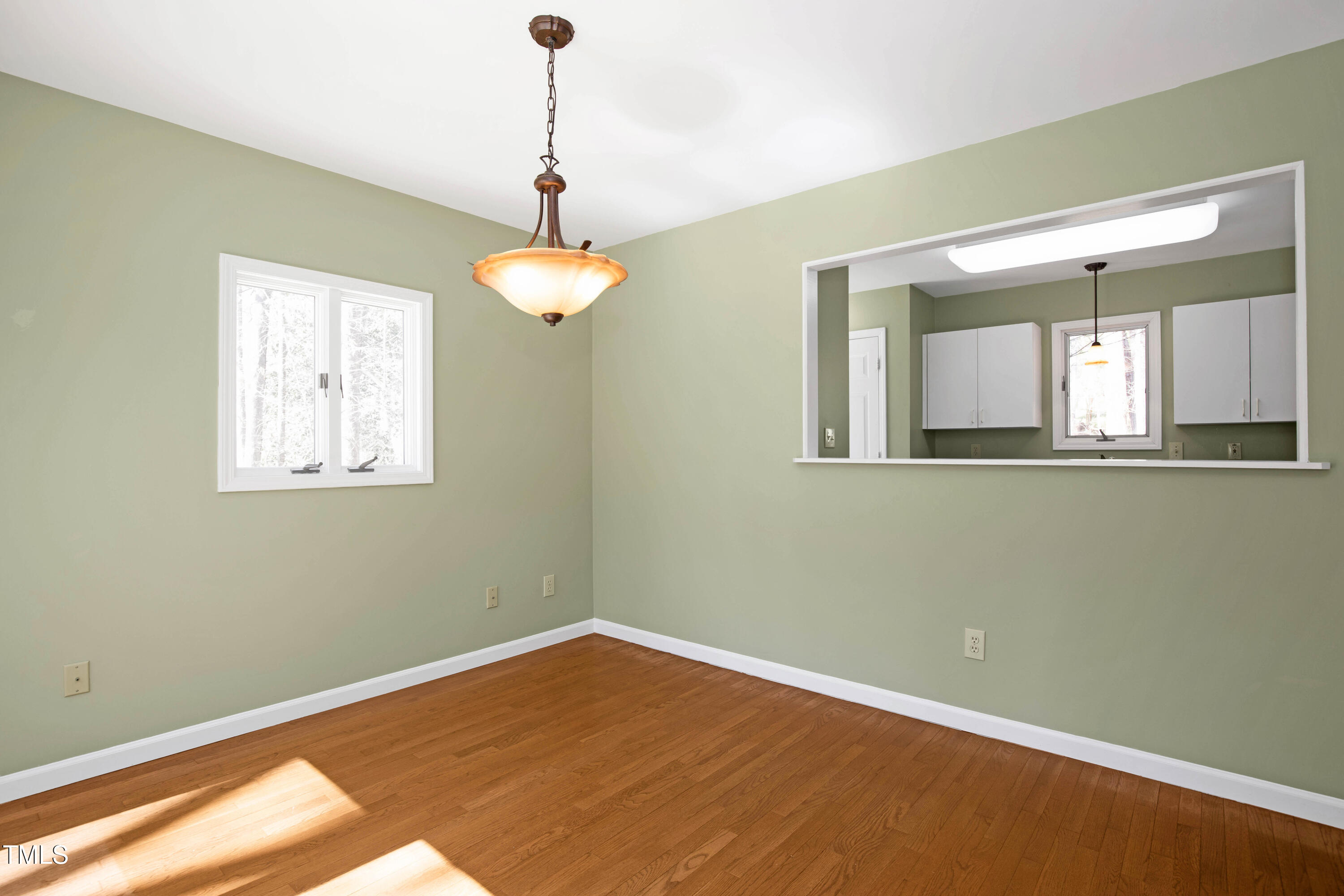 7409 Birch Tree Lane Wake Forest, NC 27587 - Photo 27 of 72 a view of an empty room with wooden floor and a window