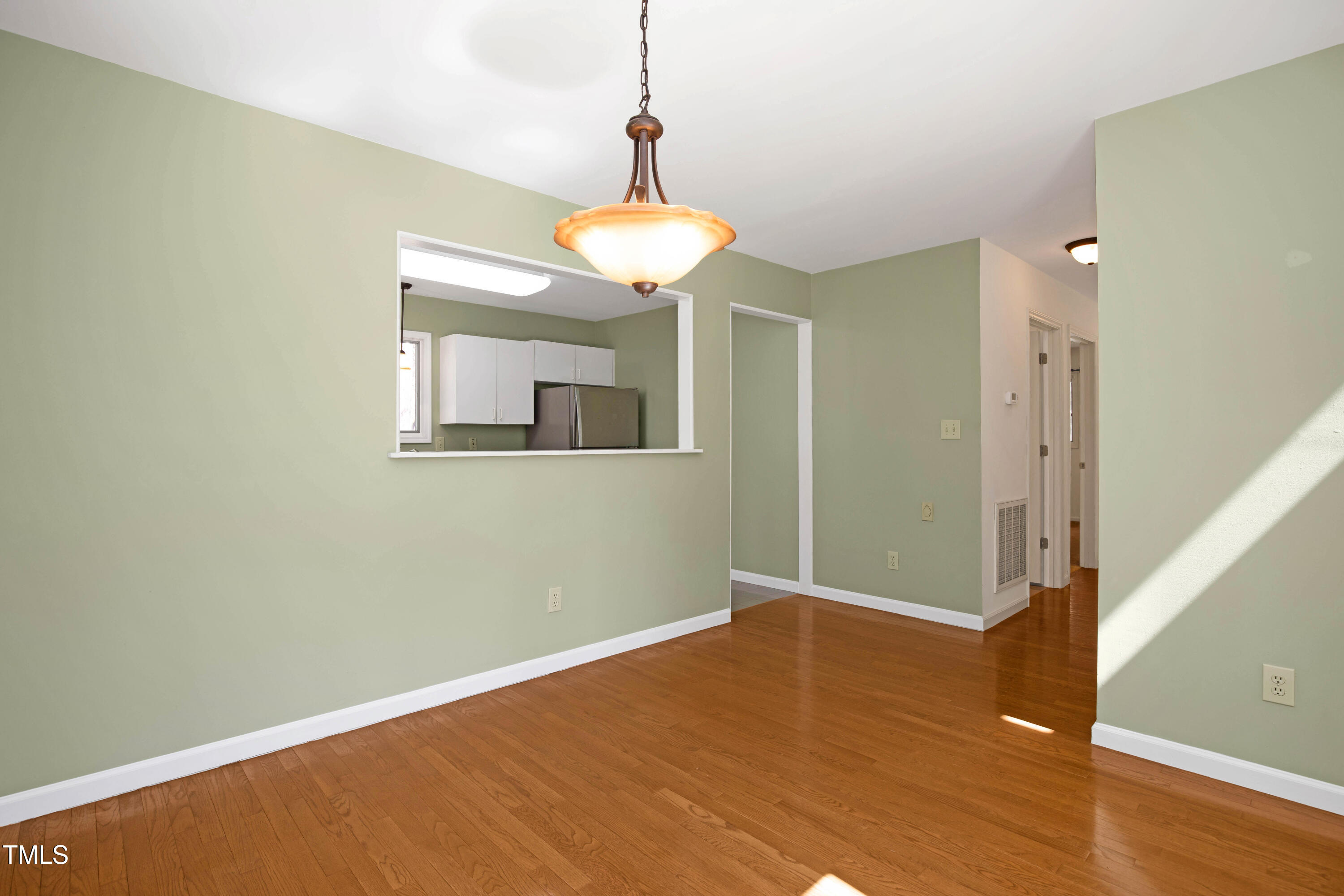 7409 Birch Tree Lane Wake Forest, NC 27587 - Photo 30 of 72 a view of an empty room with wooden floor and a window
