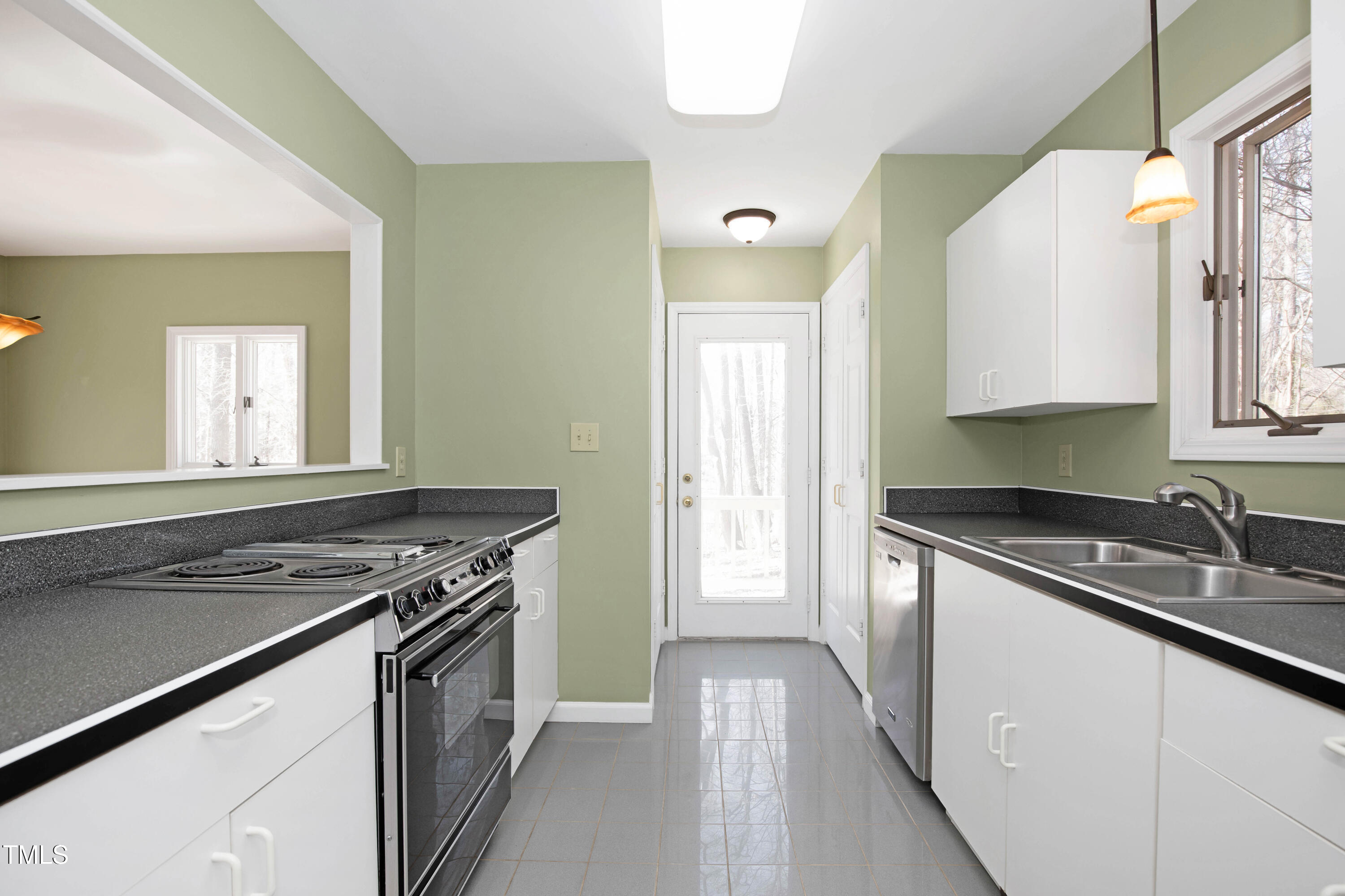 7409 Birch Tree Lane Wake Forest, NC 27587 - Photo 31 of 72 a kitchen with stainless steel appliances granite countertop a sink stove and cabinets