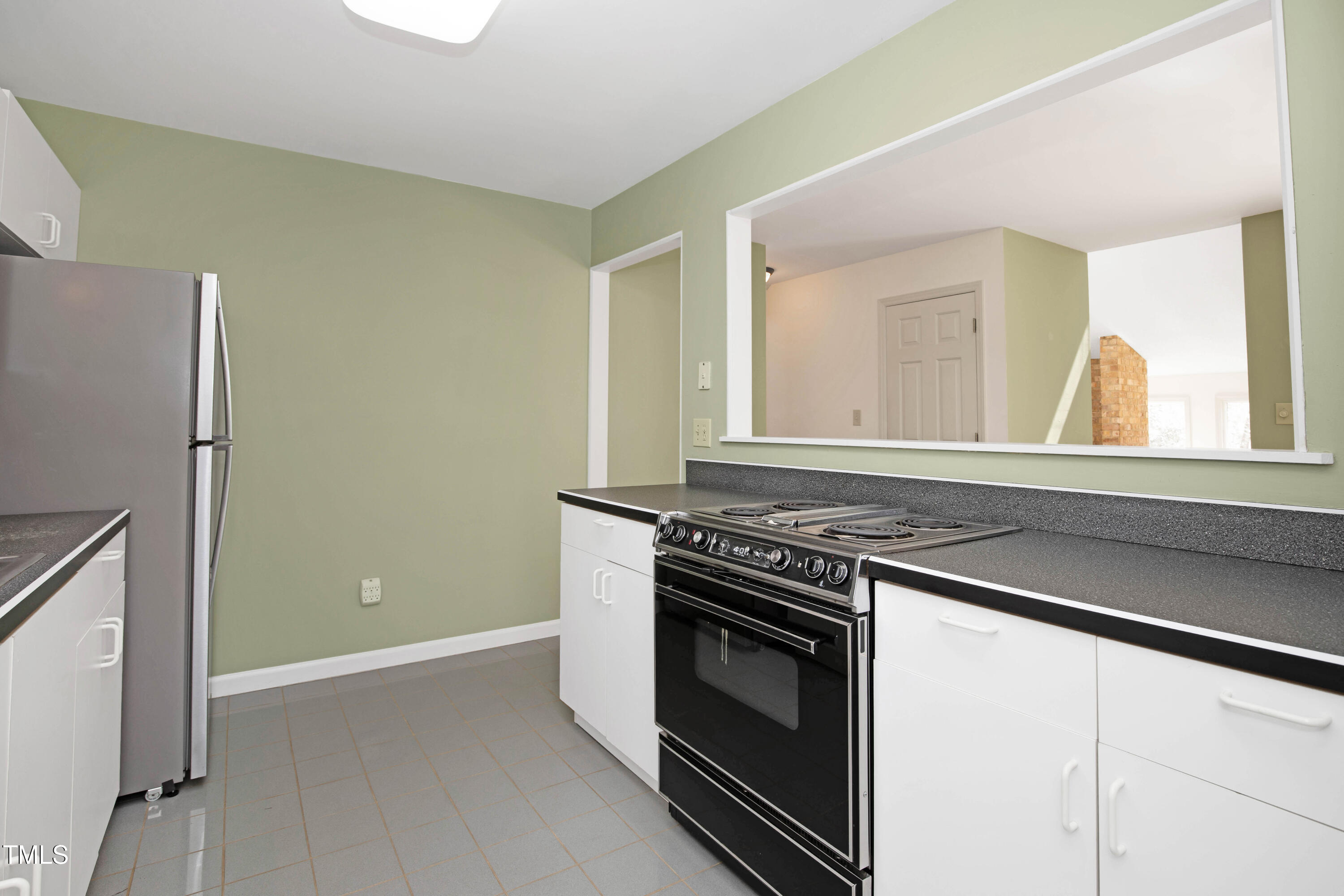 7409 Birch Tree Lane Wake Forest, NC 27587 - Photo 34 of 72 a kitchen with a stove and a microwave