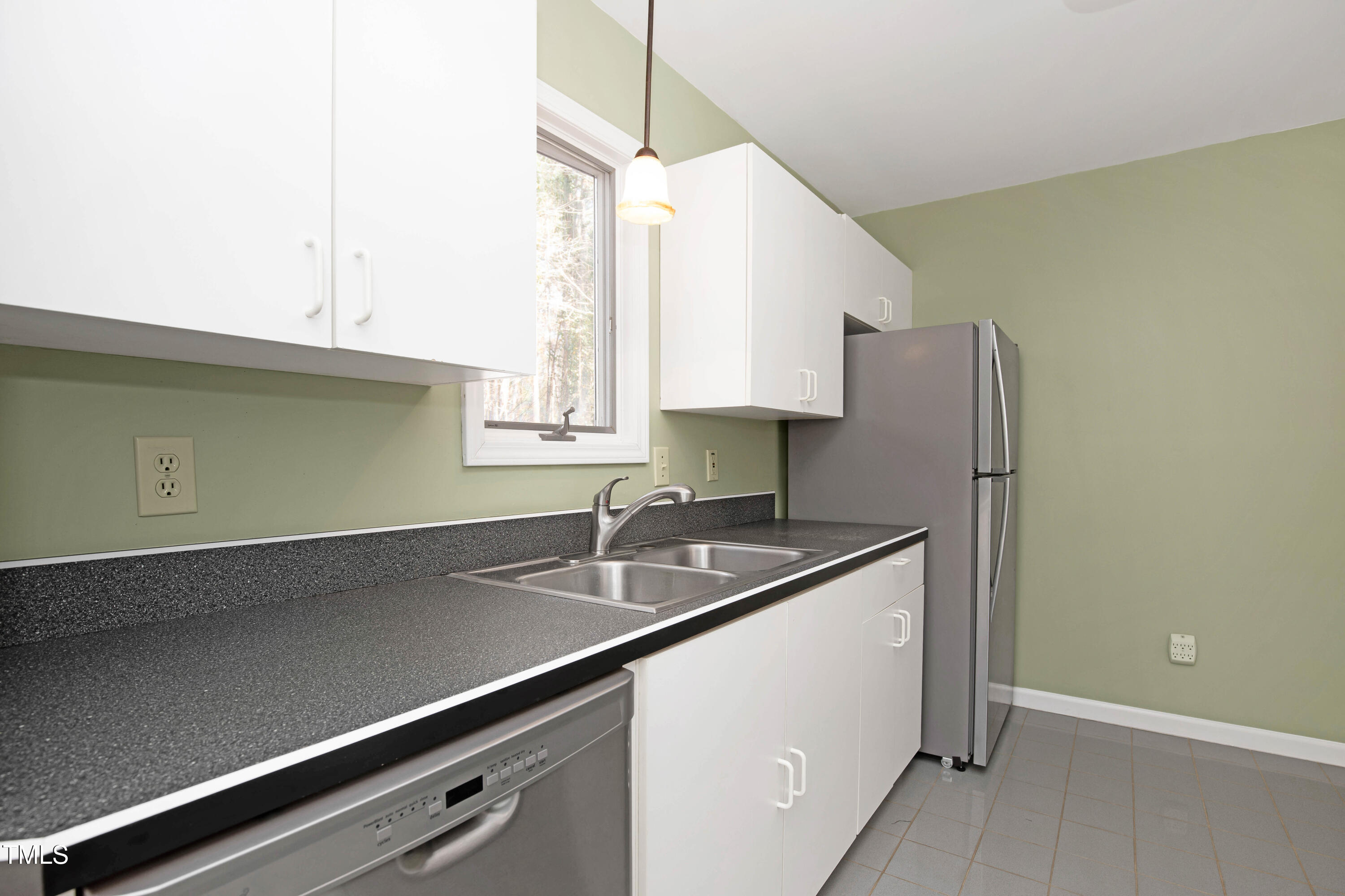 7409 Birch Tree Lane Wake Forest, NC 27587 - Photo 35 of 72 a kitchen with stainless steel appliances granite countertop a sink and a refrigerator