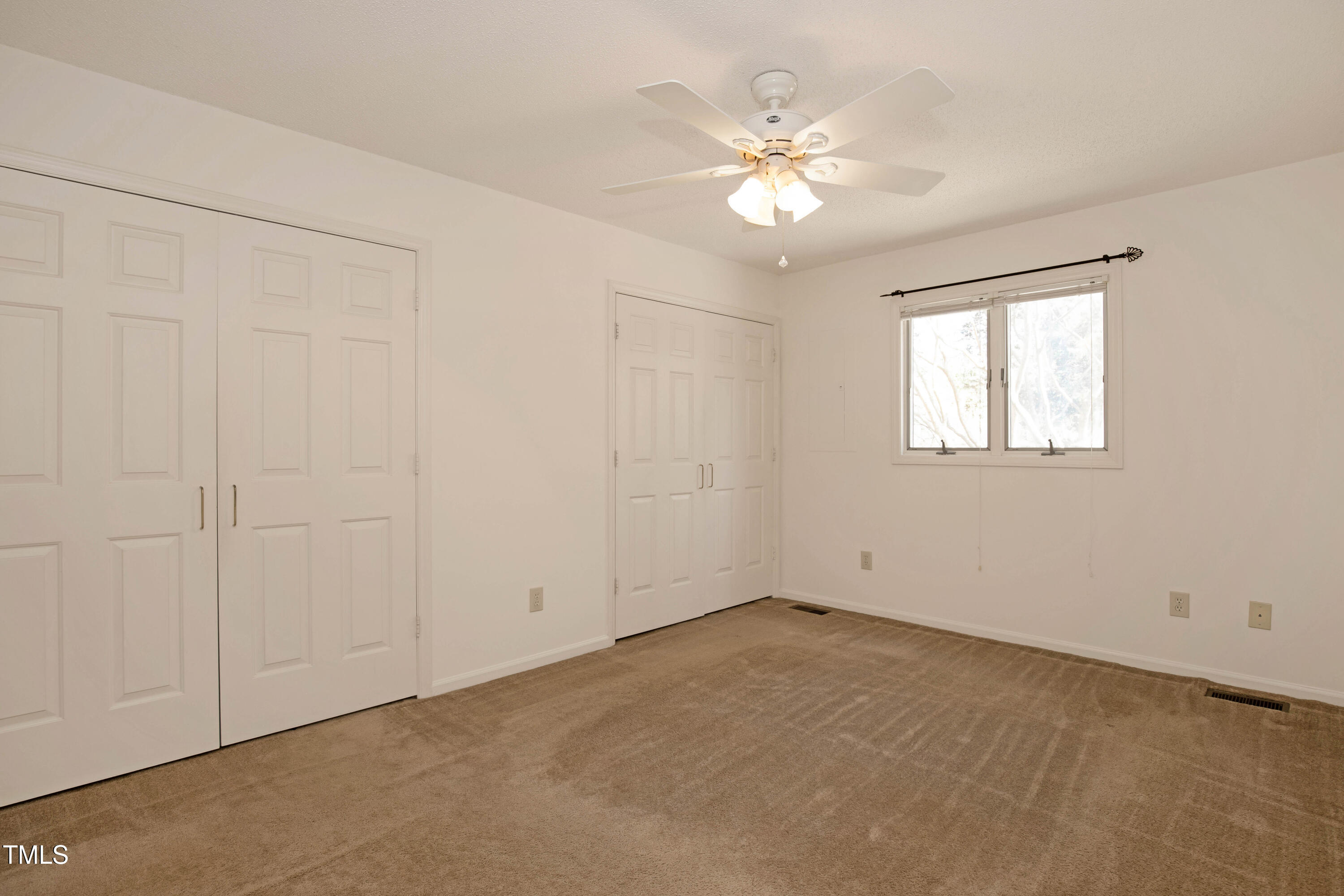 7409 Birch Tree Lane Wake Forest, NC 27587 - Photo 38 of 72 an empty room with windows and chandelier fan