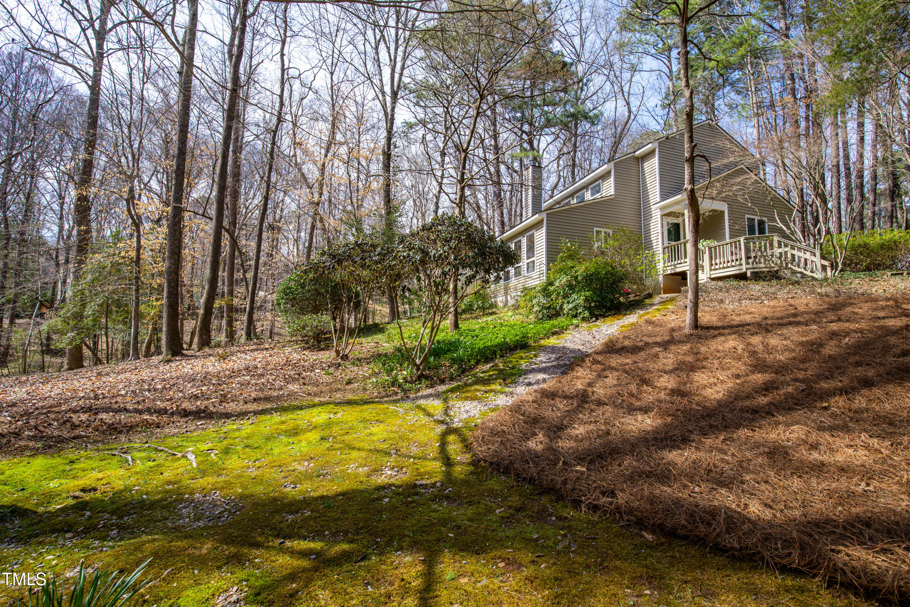 7409 Birch Tree Lane Wake Forest, NC 27587 - Photo 4 of 72 a view of a house with large trees and a yard
