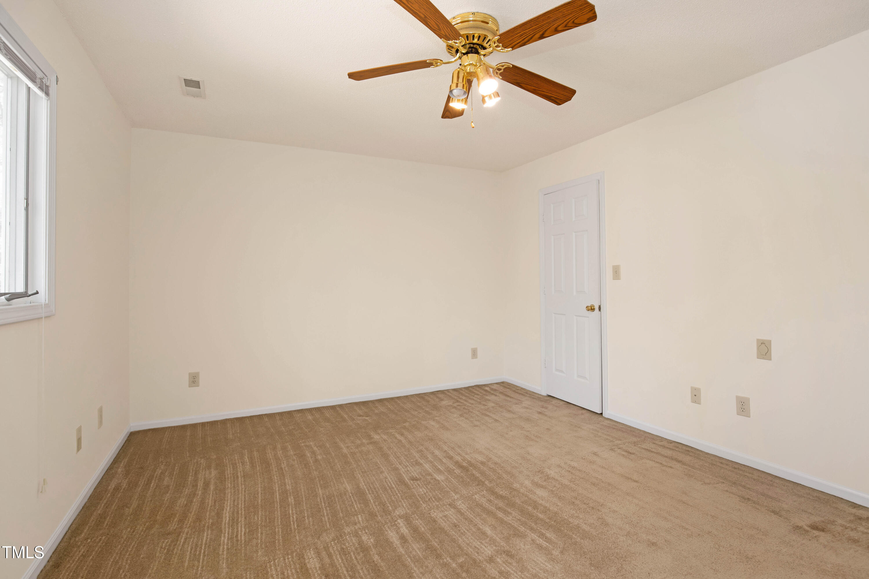 7409 Birch Tree Lane Wake Forest, NC 27587 - Photo 44 of 72 an empty room with a window and a fan