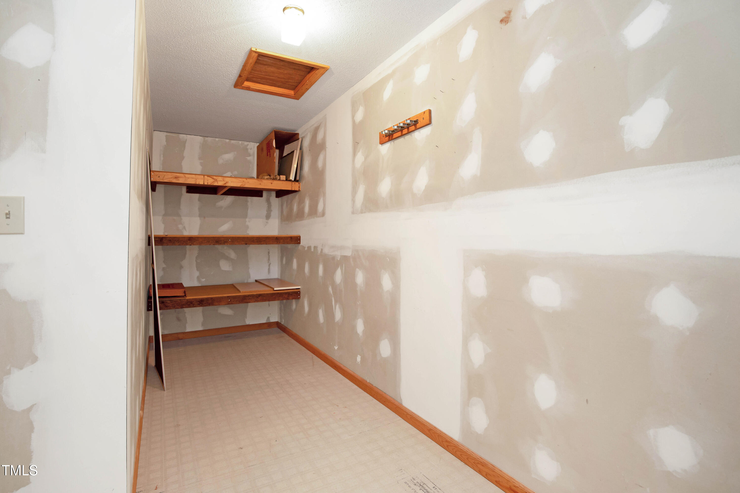 7409 Birch Tree Lane Wake Forest, NC 27587 - Photo 48 of 72 a hallway with a book shelf