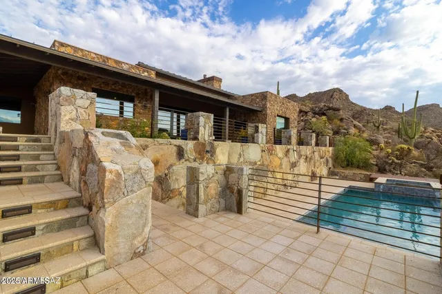 a view of a house with wooden fence