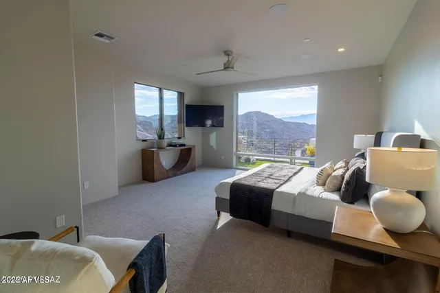 a bedroom with furniture and a large window