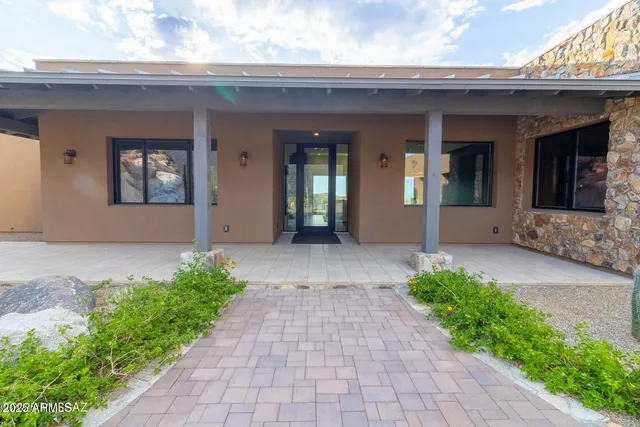 a view of a house with brick walls