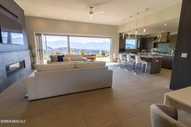 a living room with couches and kitchen view