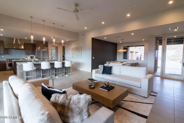 a living room with furniture and kitchen view