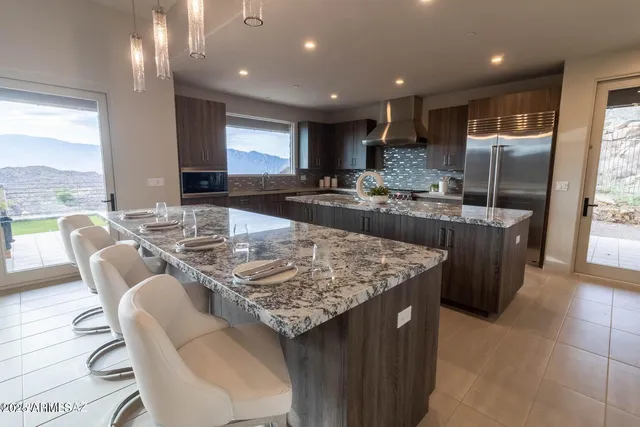 a large kitchen with a table and chairs