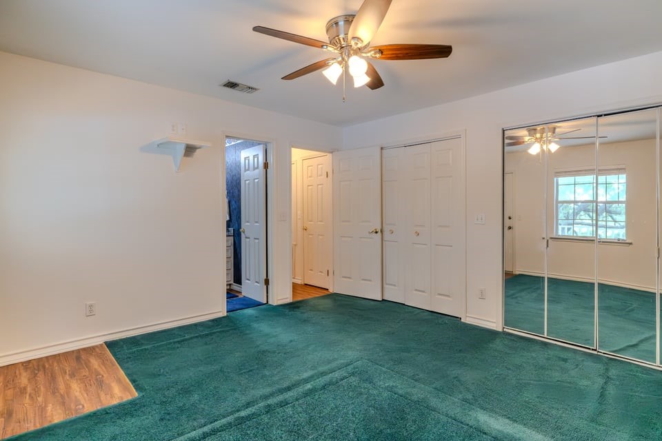 483 Riverside Drive Palacios, TX 77465 - Photo 20 of 41 wooden floor in an empty room with a window