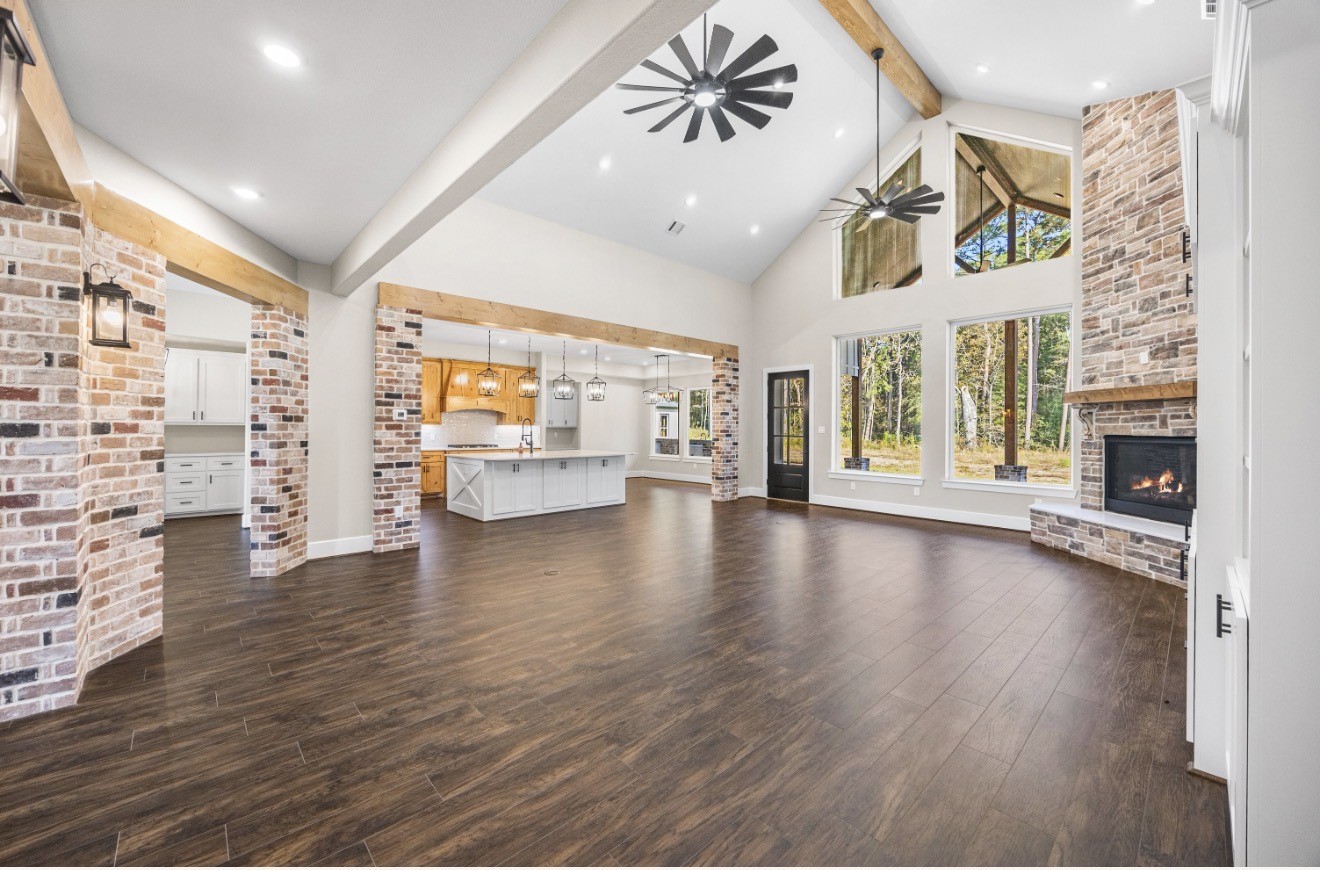41 A Pausel Road Huntsville, TX 77340 - Photo 12 of 34 a view of an empty room with window and wooden floor