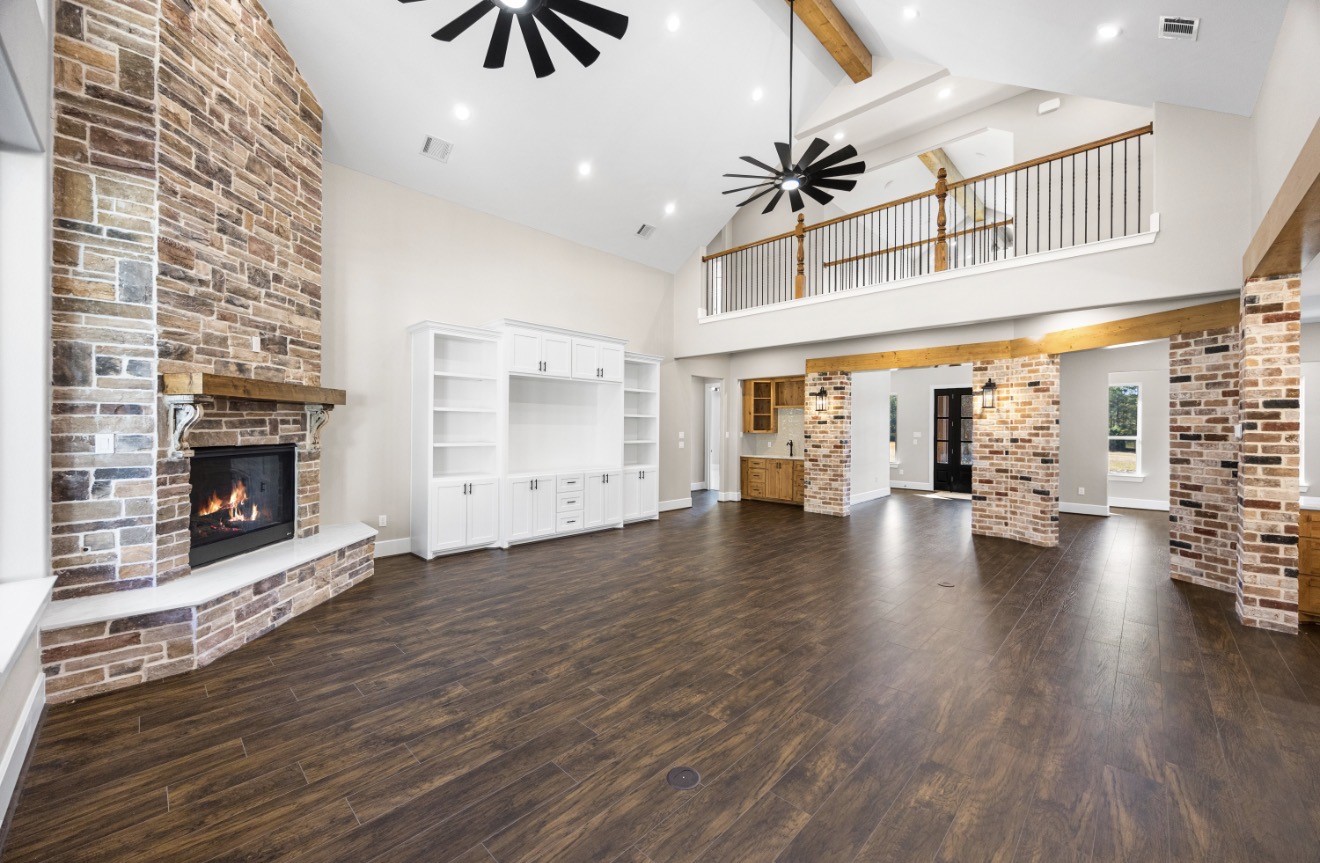 41 A Pausel Road Huntsville, TX 77340 - Photo 14 of 34 an empty room with wooden floor fireplace and windows