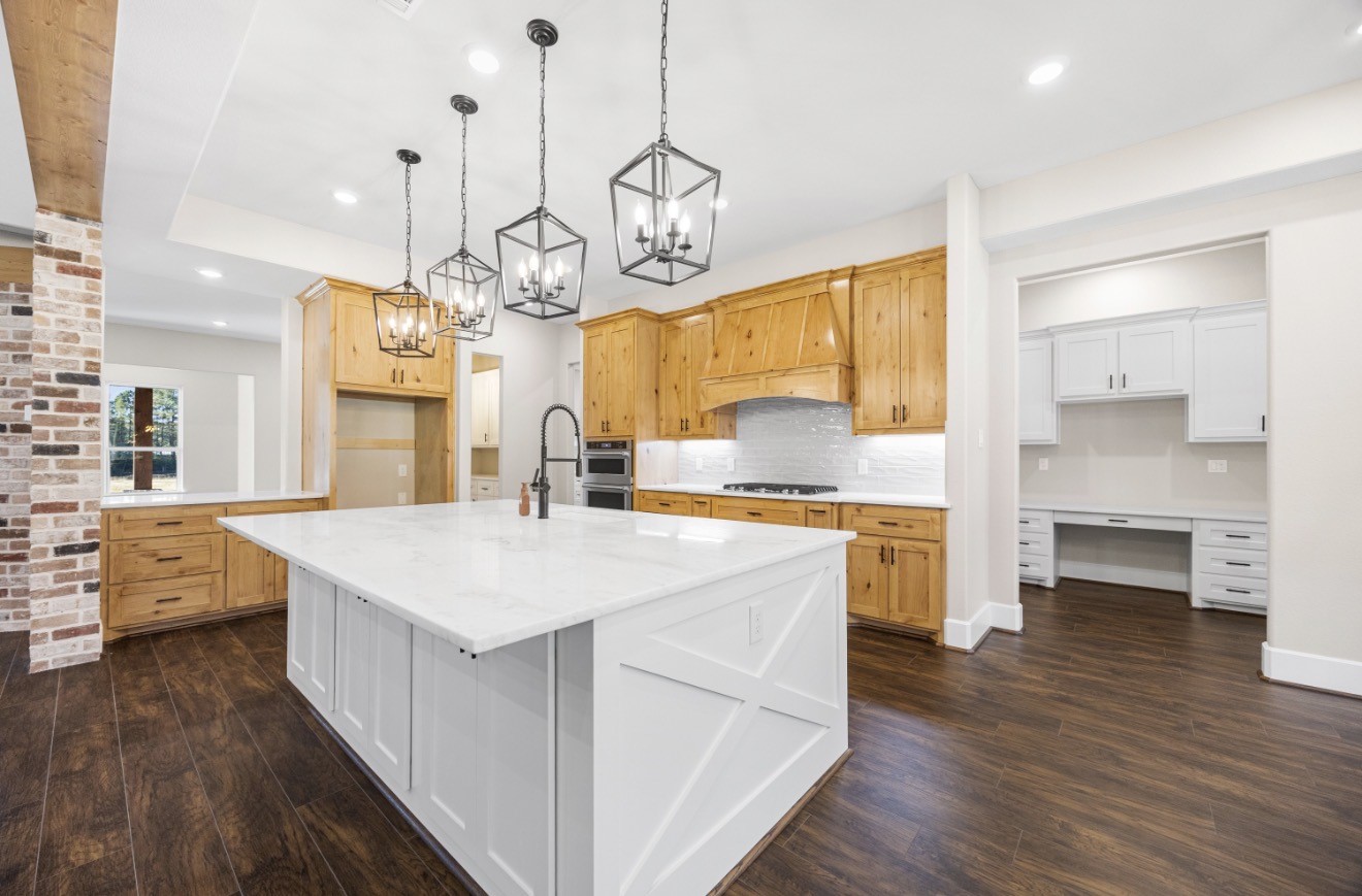 41 A Pausel Road Huntsville, TX 77340 - Photo 15 of 34 a large kitchen with kitchen island a stove a sink a center island and wooden floor