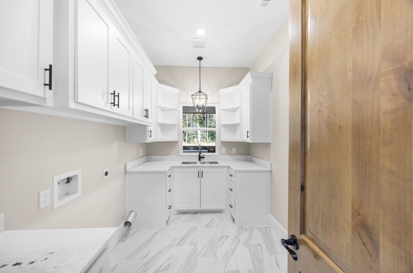 41 A Pausel Road Huntsville, TX 77340 - Photo 21 of 34 a kitchen with a sink cabinets and window