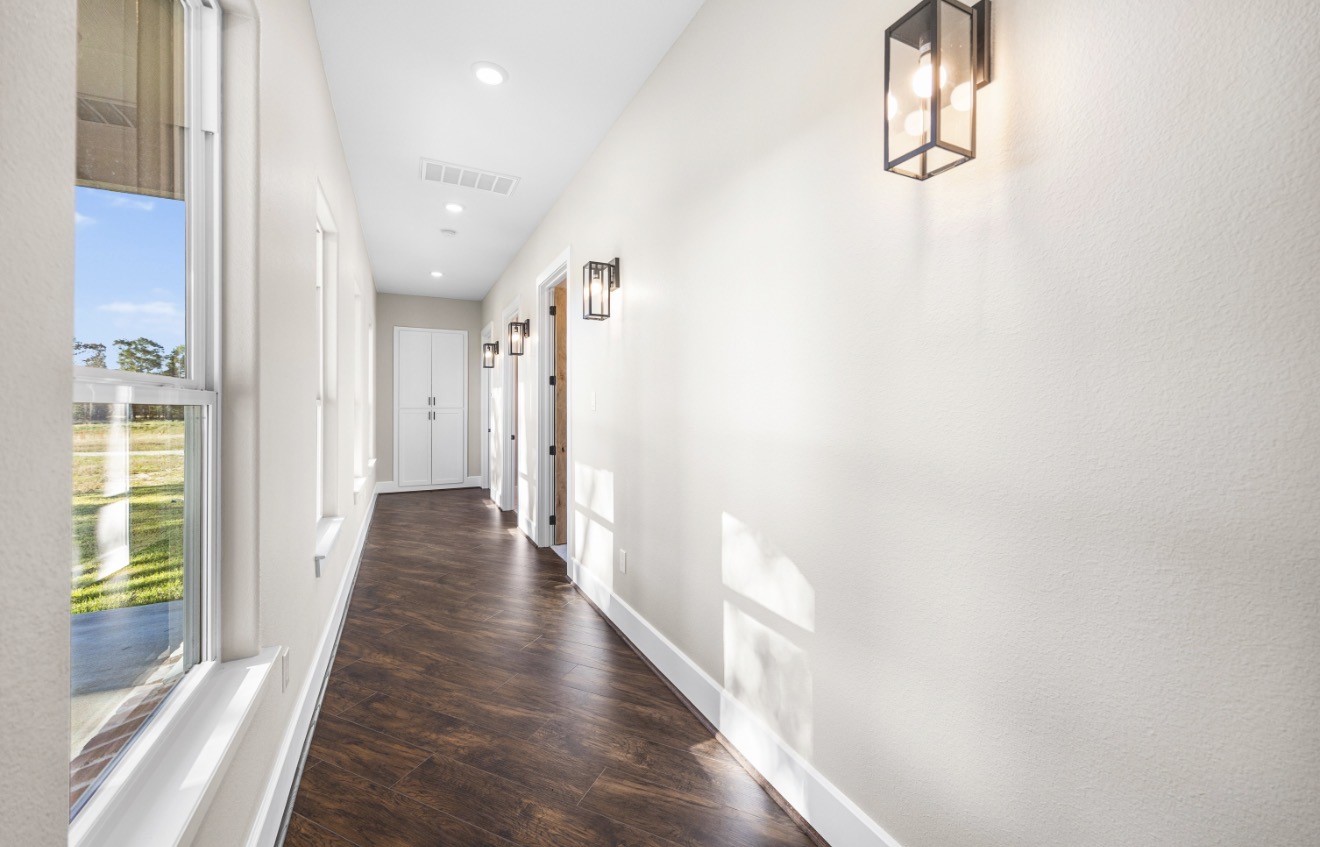 41 A Pausel Road Huntsville, TX 77340 - Photo 22 of 34 a view of a hallway with wooden floor and staircase