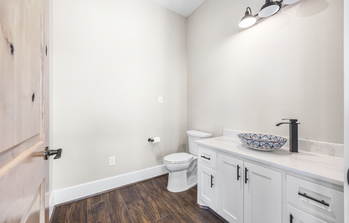 41 A Pausel Road Huntsville, TX 77340 - Photo 24 of 34 a bathroom with a granite countertop toilet and a sink