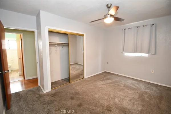 a view of an empty room and wooden floor