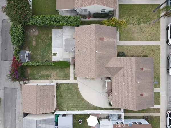 an aerial view of a house with a yard