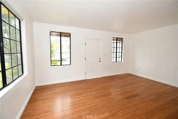 a view of a kitchen with wooden floor and a sink
