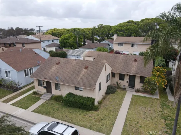 an aerial view of a house with a yard