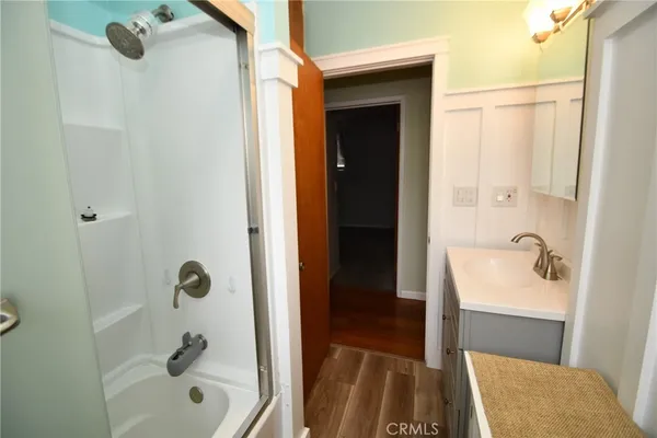 a view of hallway with wooden floor