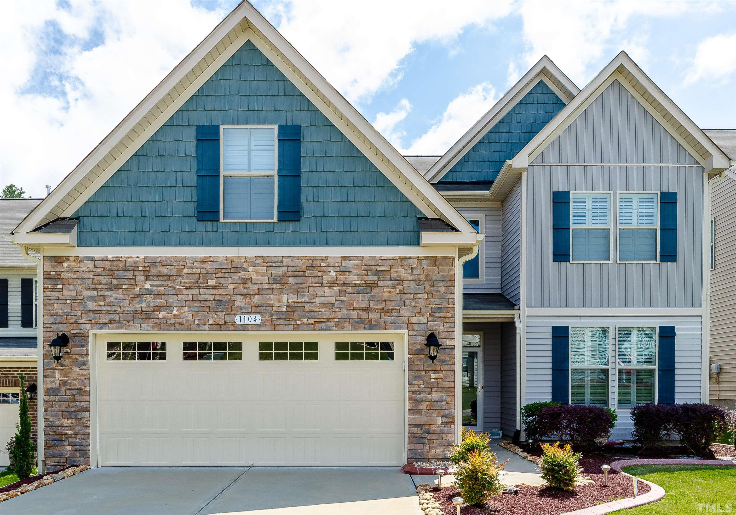 a view of a brick house with large windows