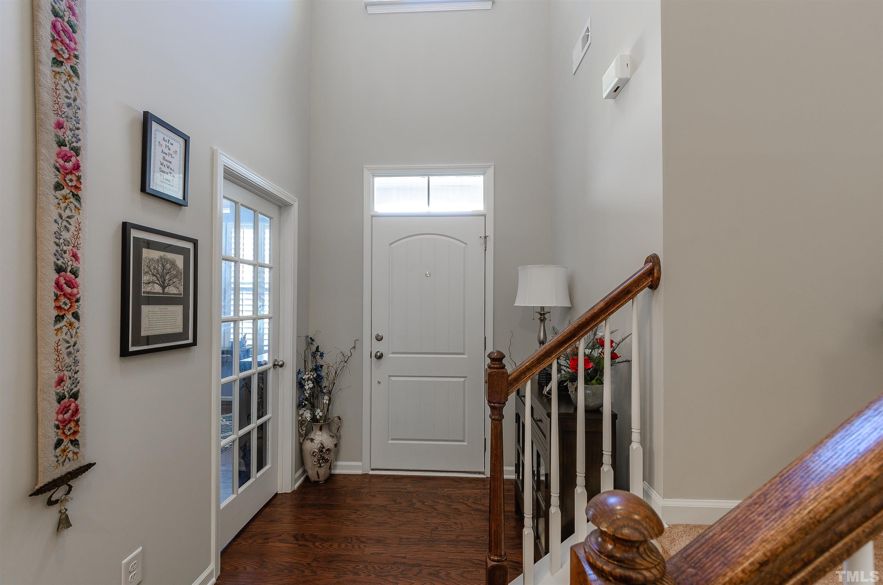 1104 Big Spring Circle Durham, NC 27703 - Photo 13 of 47 a view of entryway with stairs and wooden floor