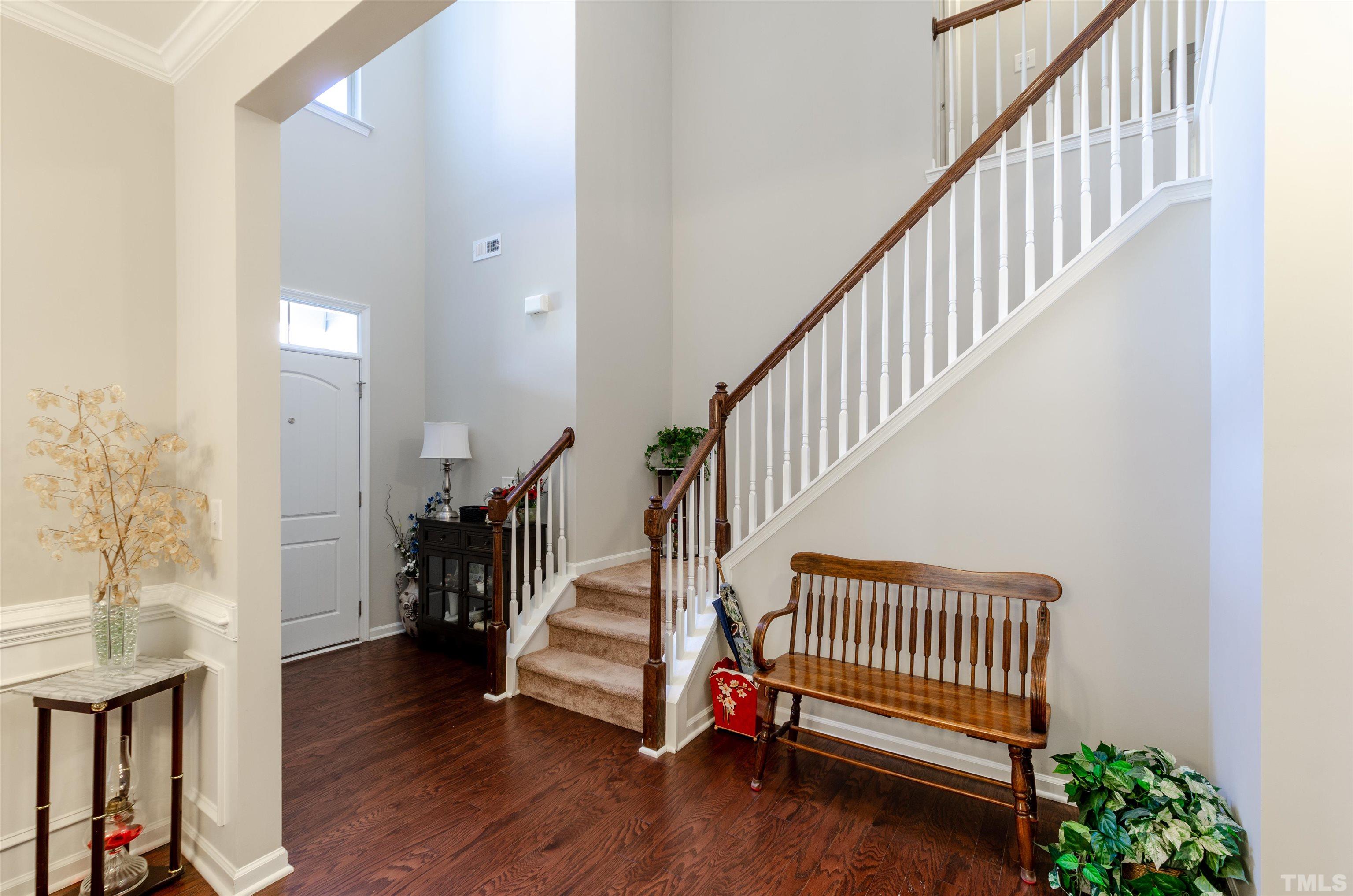 1104 Big Spring Circle Durham, NC 27703 - Photo 14 of 47 a view of entryway with wooden floor and stairs