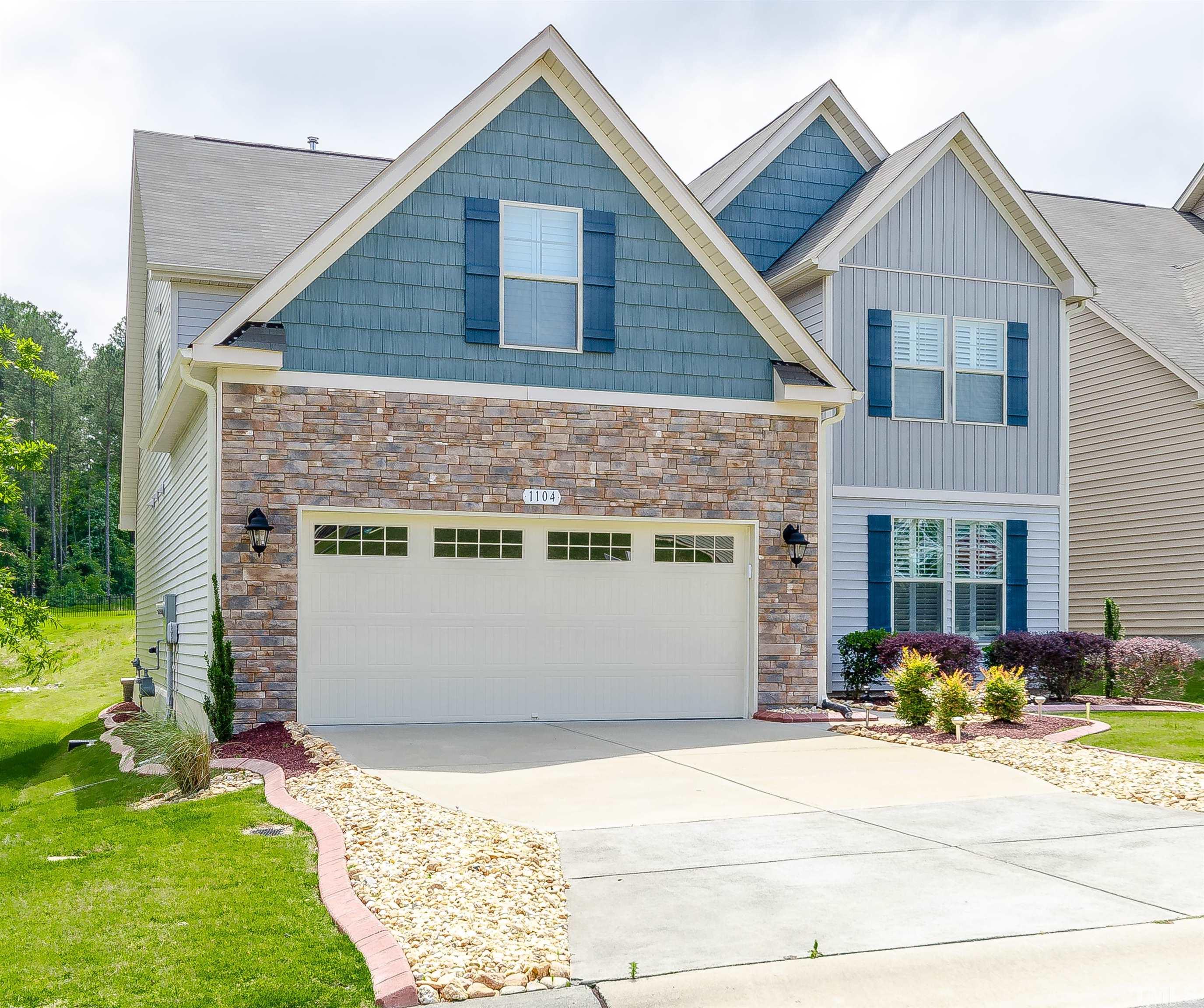 1104 Big Spring Circle Durham, NC 27703 - Photo 3 of 47 a front view of a house with a yard