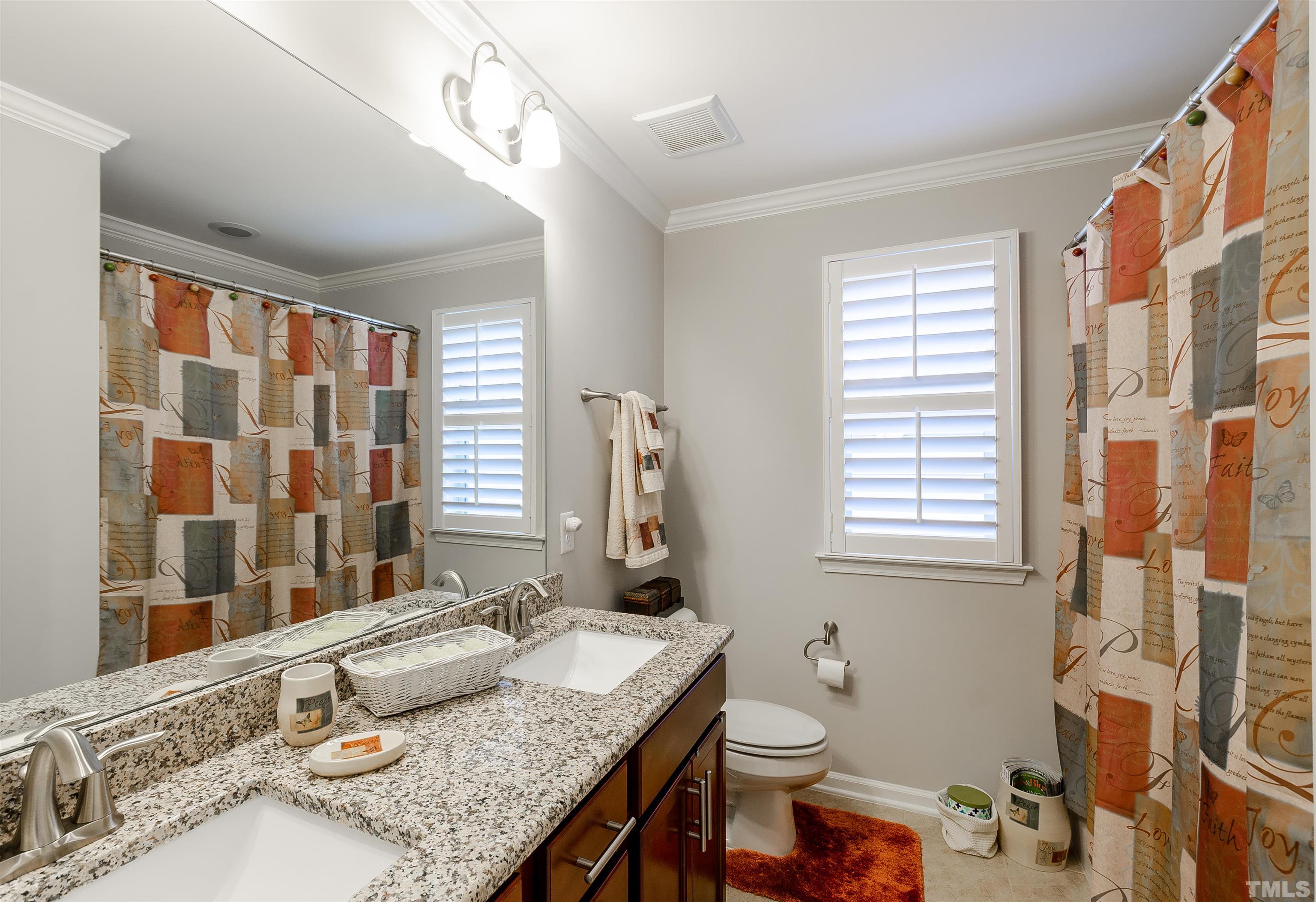 1104 Big Spring Circle Durham, NC 27703 - Photo 35 of 47 a bathroom with a granite countertop sink and a mirror