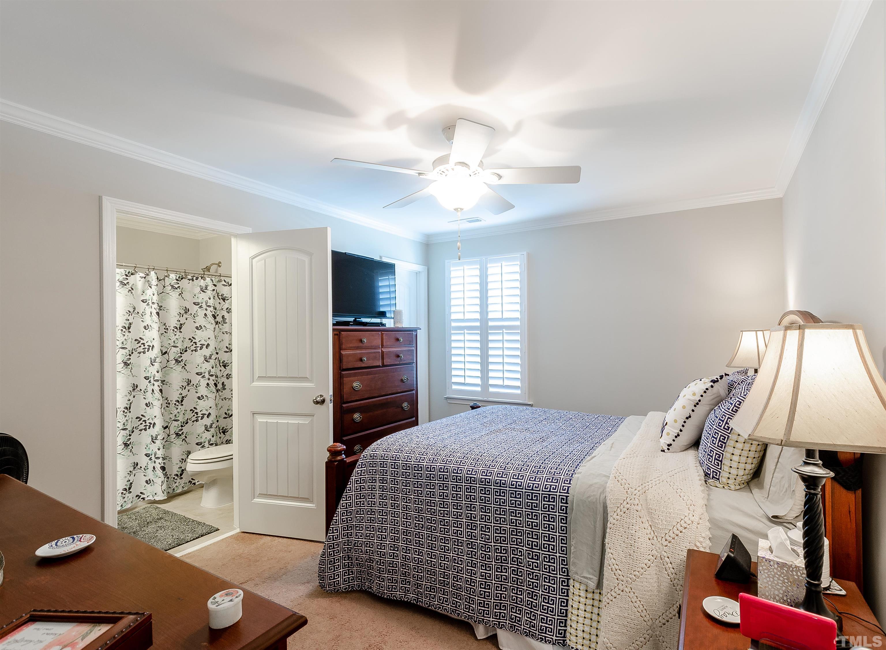 1104 Big Spring Circle Durham, NC 27703 - Photo 37 of 47 a bedroom with a bed and a chandelier