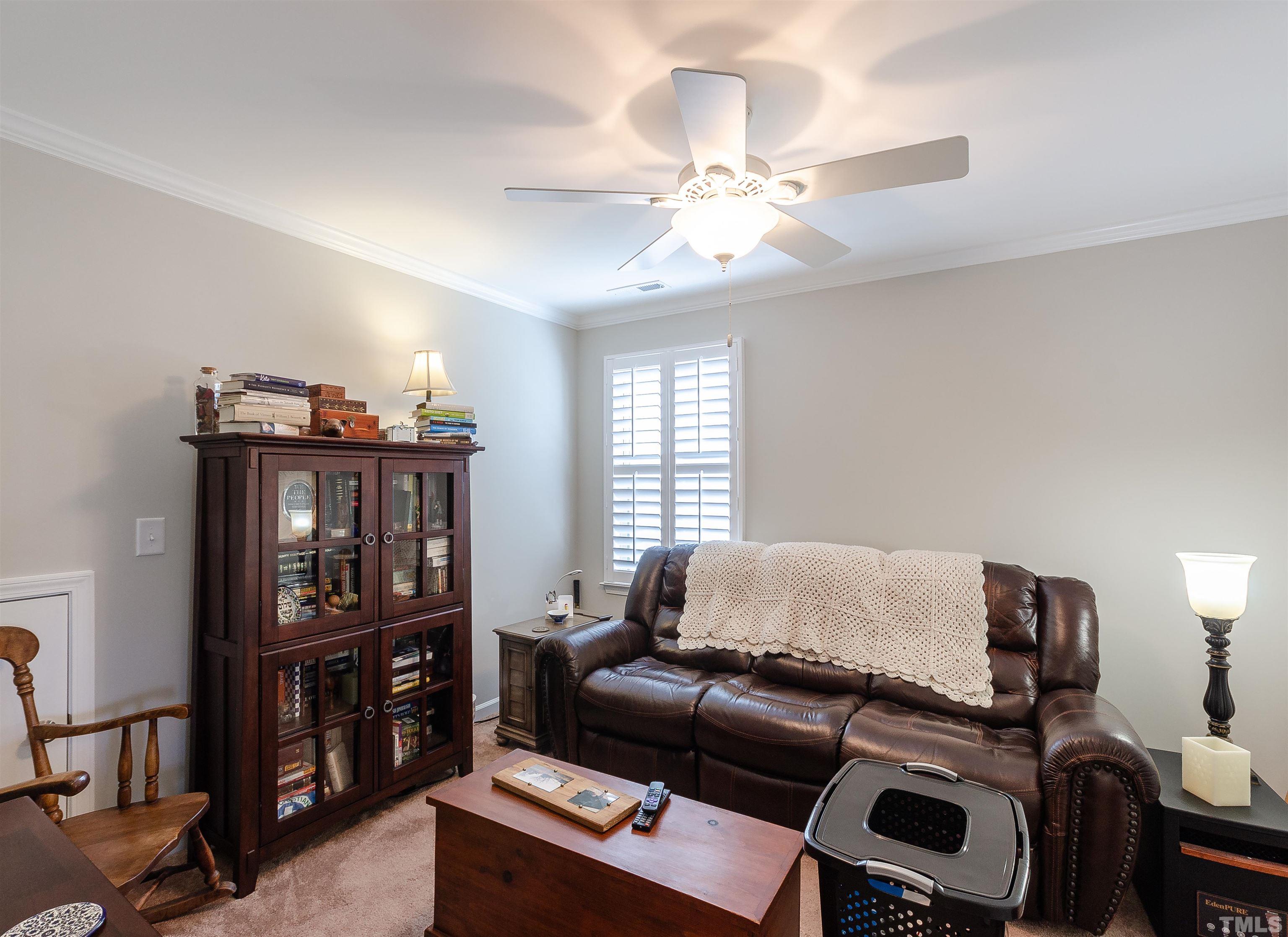 1104 Big Spring Circle Durham, NC 27703 - Photo 38 of 47 a living room with furniture a ceiling fan and a window