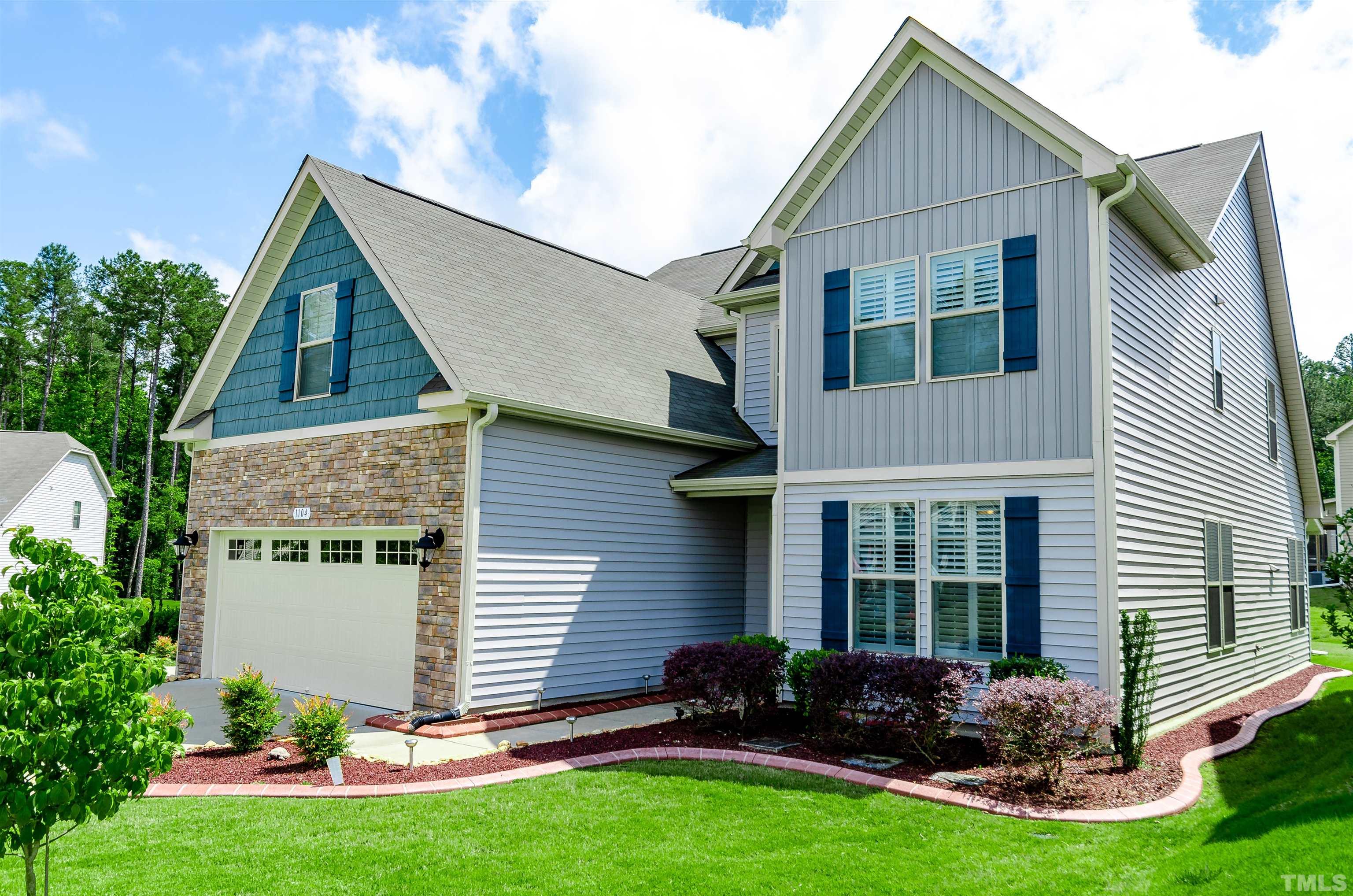 1104 Big Spring Circle Durham, NC 27703 - Photo 4 of 47 a front view of a house with garden