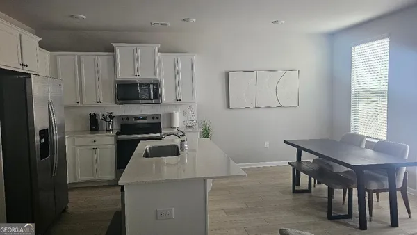 a kitchen with cabinets and stainless steel appliances