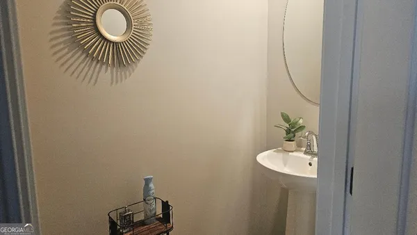 a bathroom with a sink and mirror
