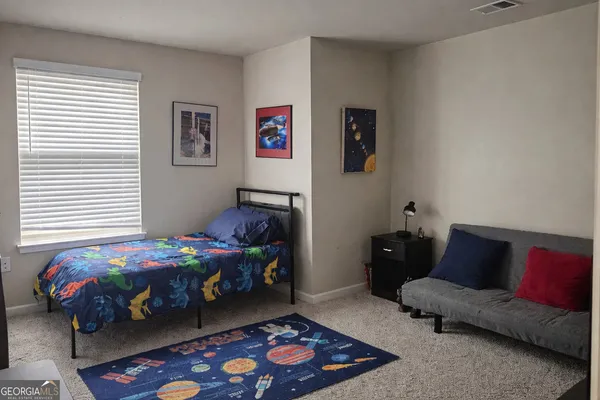 a bedroom with a bed and a couch