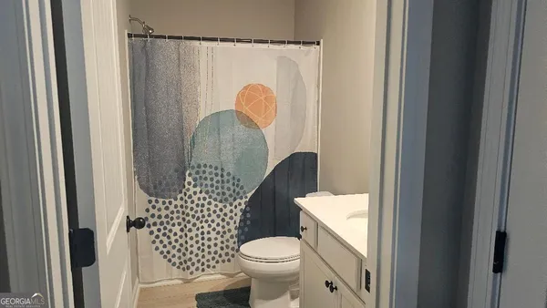 a white toilet sitting next to a bathroom sink