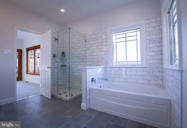 a spacious bathroom with a glass shower door